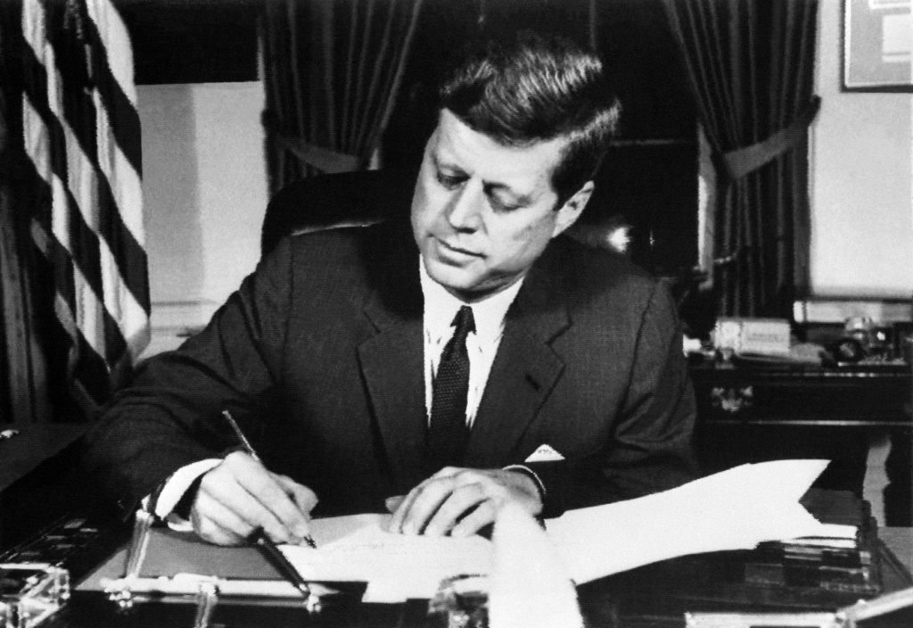 US President John Fitzgerald Kennedy signs the order of a naval blockade of Cuba, on October 23, 1962 in White House, Washington DC, during the Cuban missile crisis.