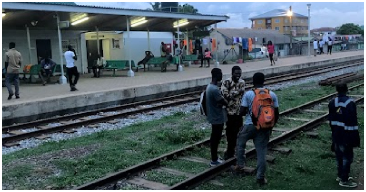 People stand on the railway tracks in Achimota