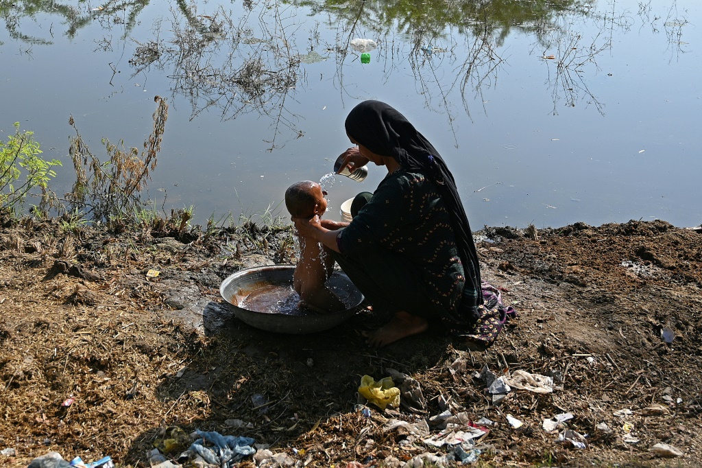 A Pakistani mother and child, who were forced to flee their home amid devastating floods, pictured here in September in Sindh province