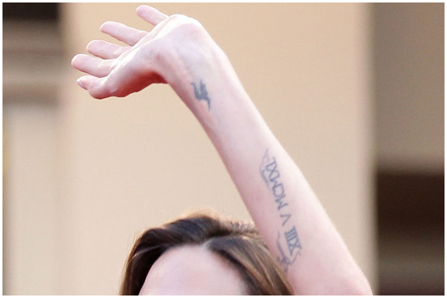 Actress Angelina Jolie's letter h tattoo is seen as she attends "The Tree Of Life" premiere during the 64th Annual Cannes Film Festival at Palais des Festivals in Cannes, France.