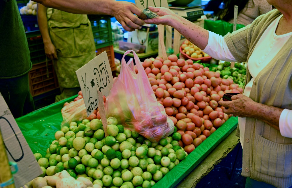 A woman buys limes at a market in Morelia, the capital of Mexico's Michoacan state