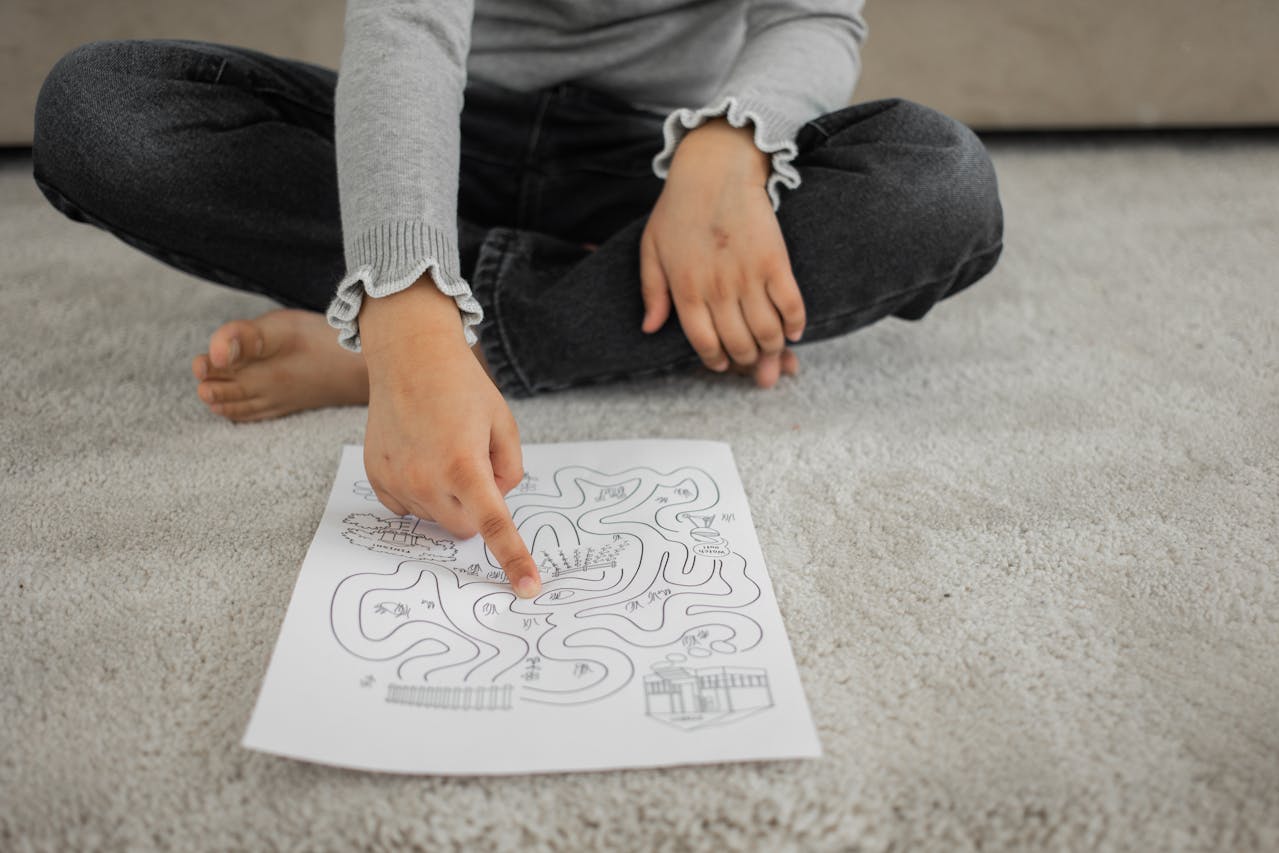 A kid sitting on a rug and playing with a puzzle