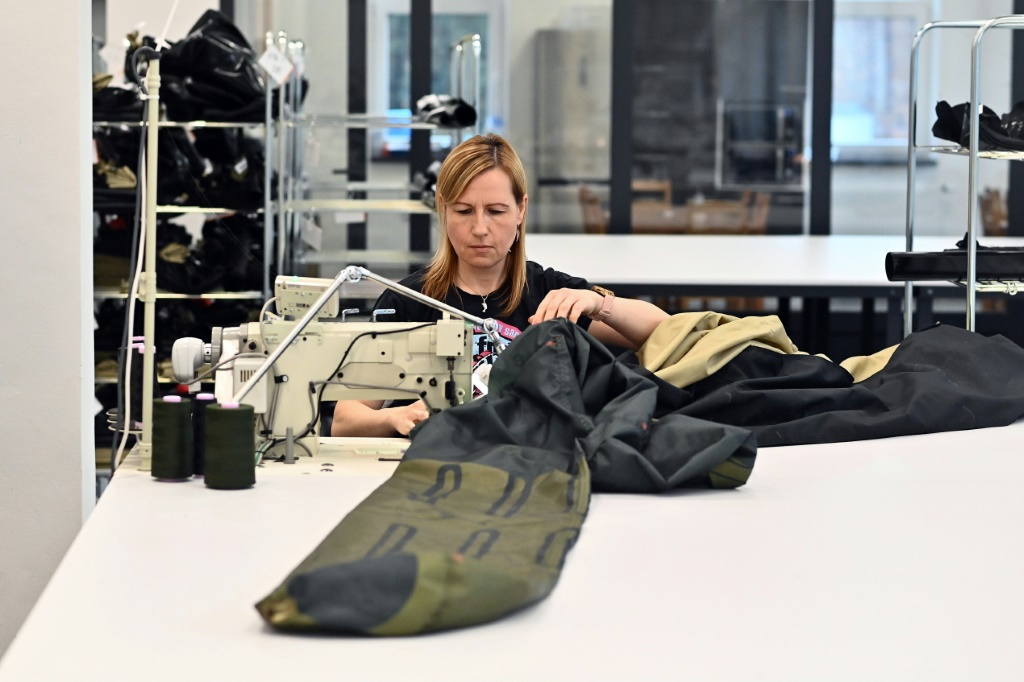 A worker sews the material for an inflatable decoy of a military vehicle in Decin. Founded eight years ago, the  Inflatech makes more than 30 types of inflatable decoy weapons
