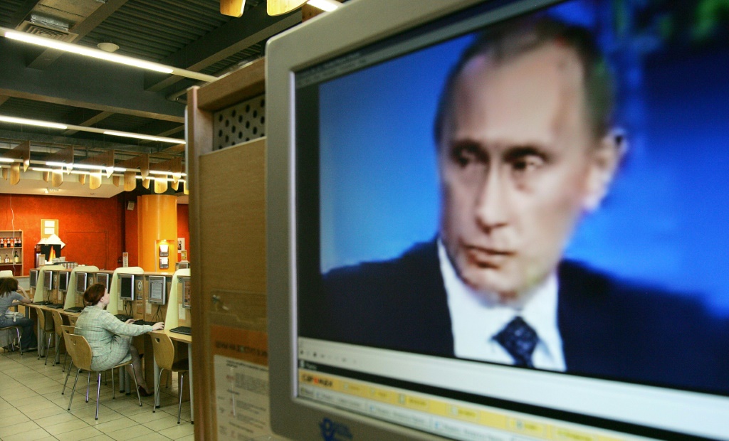 Russian President Vladimir Putin is seen on a computer screen at an internet cafe during a special interactive webcast in 2006 partly organized by the BBC, years before a crackdown on the internet in the country