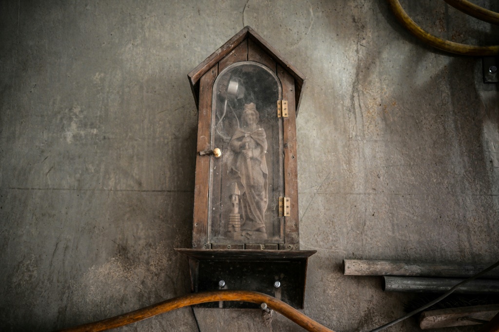 A statue of Saint Barbara, the patron of tunnelling, watches over the construction