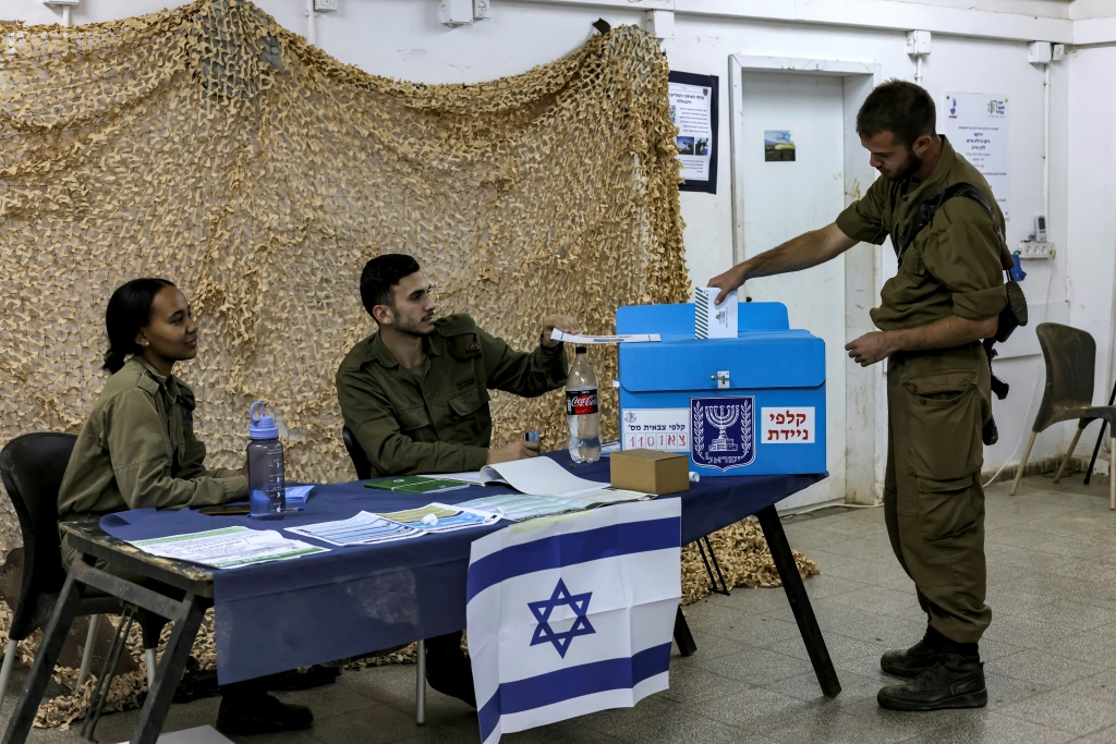 An Israeli soldier casts a ballot a day early at Har Dov military base on Mount Hermon, a strategic and fortified outpost at the crossroads between Israel, Lebanon, and Syria, in the Israeli-annexed Golan Heights
