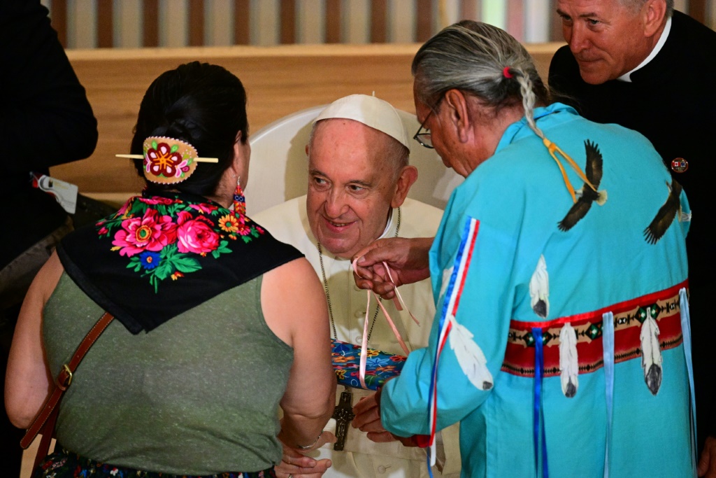 Pope Francis recieves gifts from members of the Indigenous community as he meets with them at the Sacred Heart Church of the First Peoples in Edmonton, Alberta, Canada, on July 25, 2022