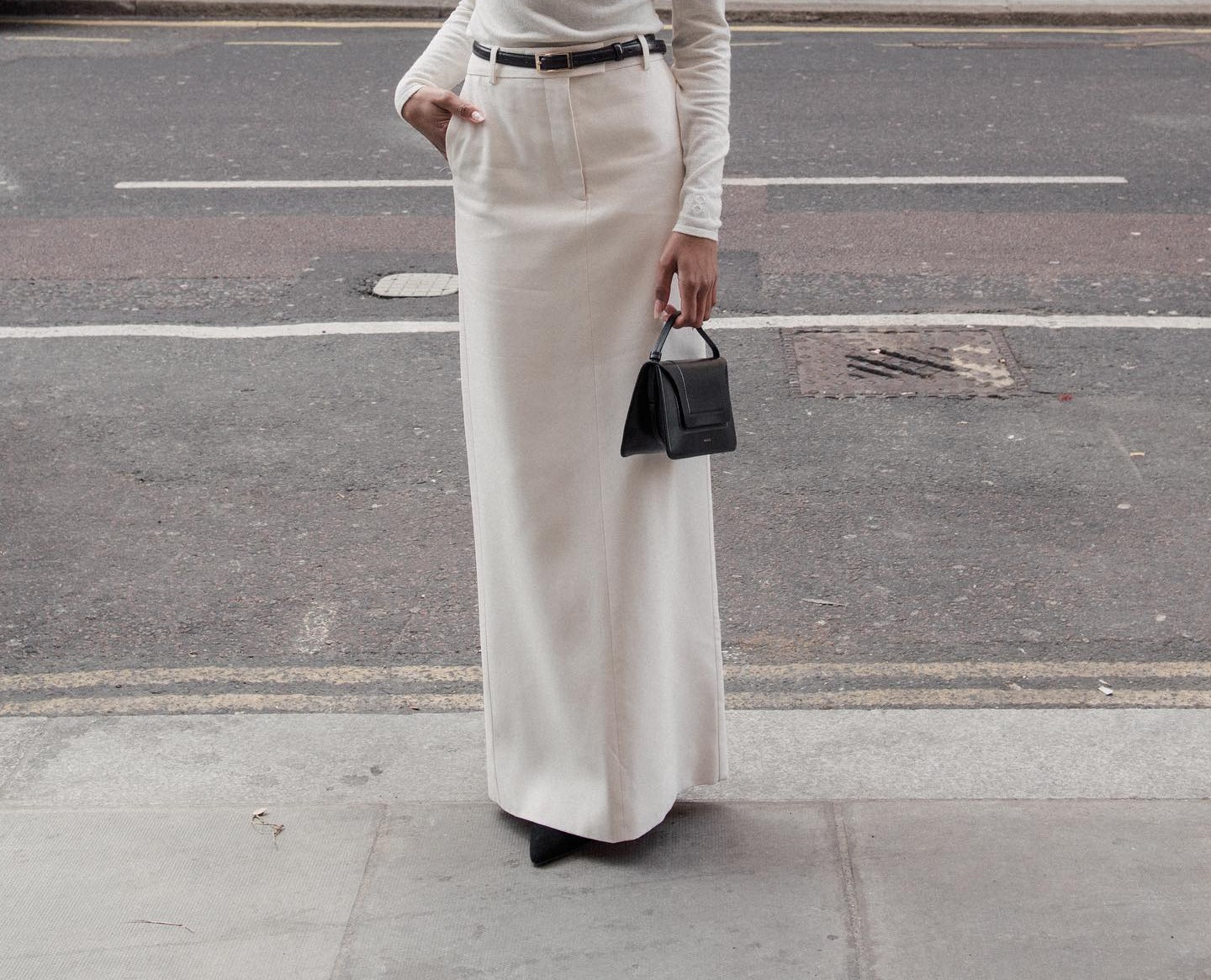 A woman in a white maxi skirt