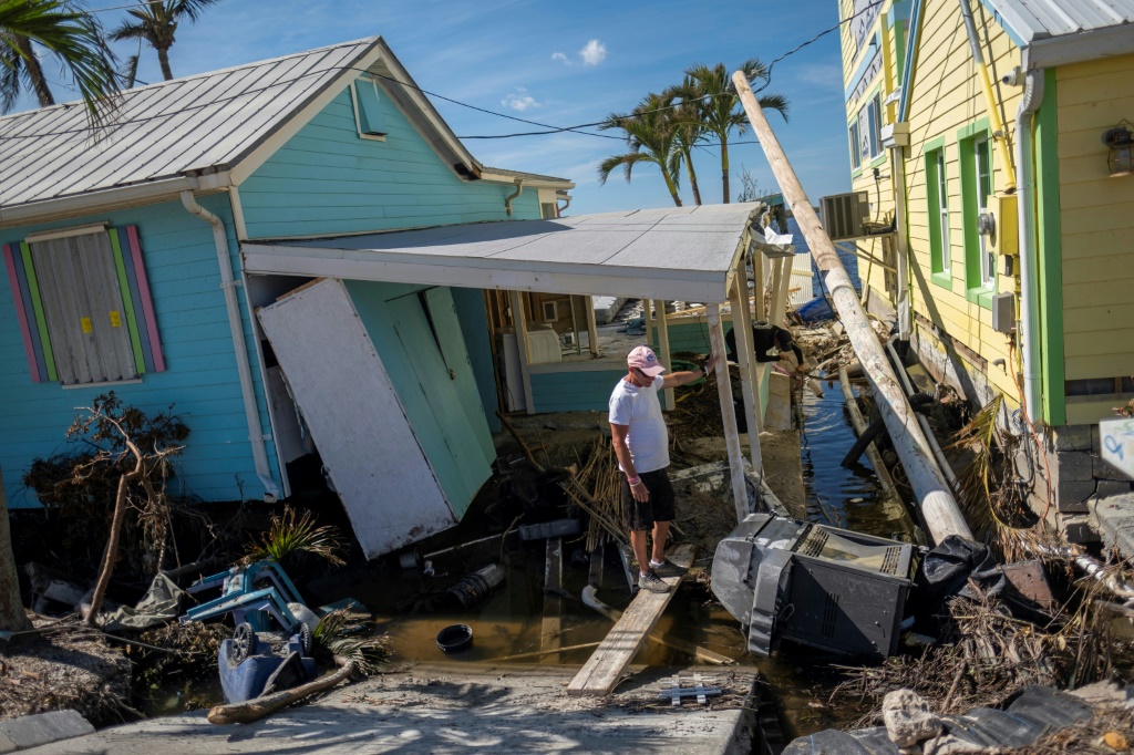 A man stands in front of his destroyed house in the aftermath of Hurricane Ian in Matlacha, Florida