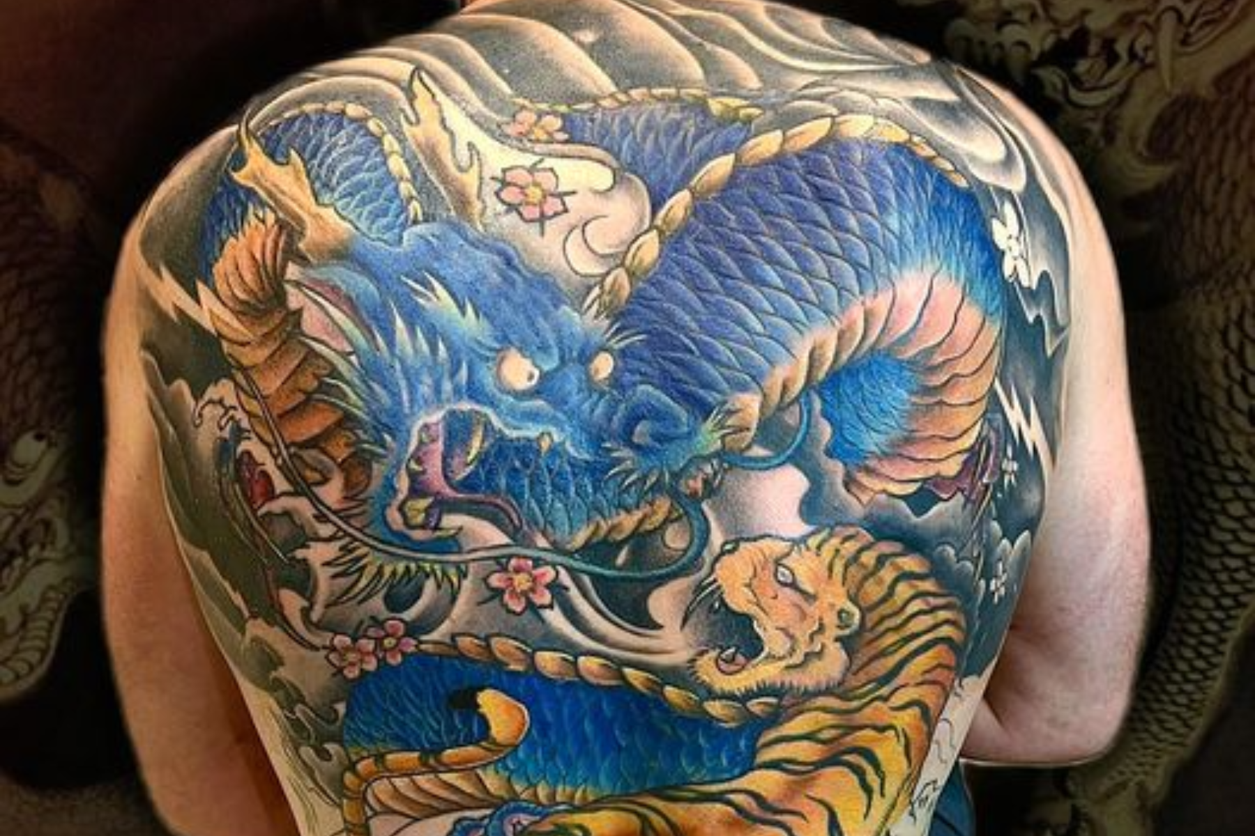 A man is wearing a full-back Japanese tattoo
