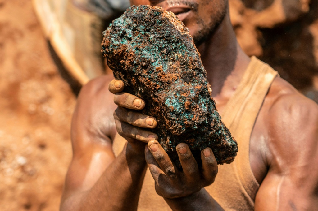 The prize: Artisanal miner Dela wa Monga holds a chunk of cobalt