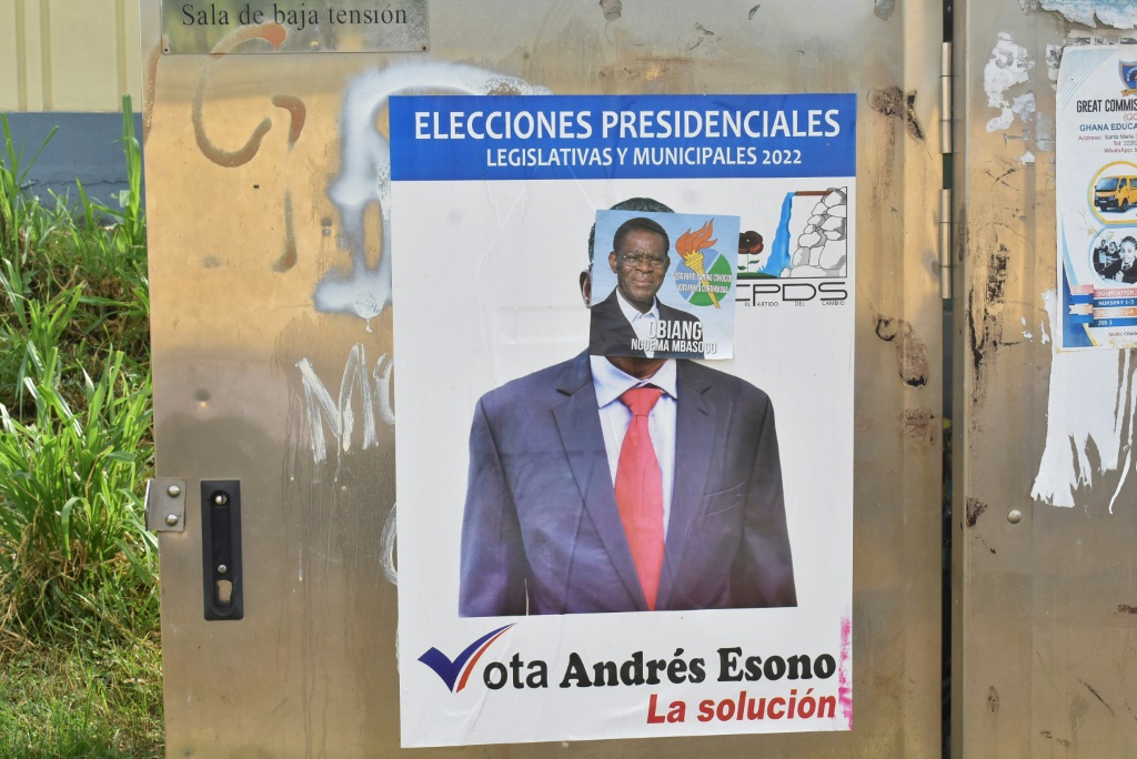 A campaign poster for Obiang is pasted over a poster of rival candidate Andres Esono Ondo of the Convergence for Social Democracy (CPDS), Equatorial Guinea's sole authorised opposition  party