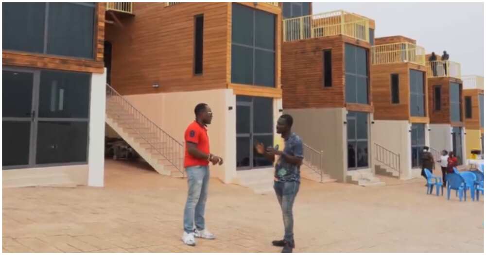 Two men discuss apartments for rent in Accra