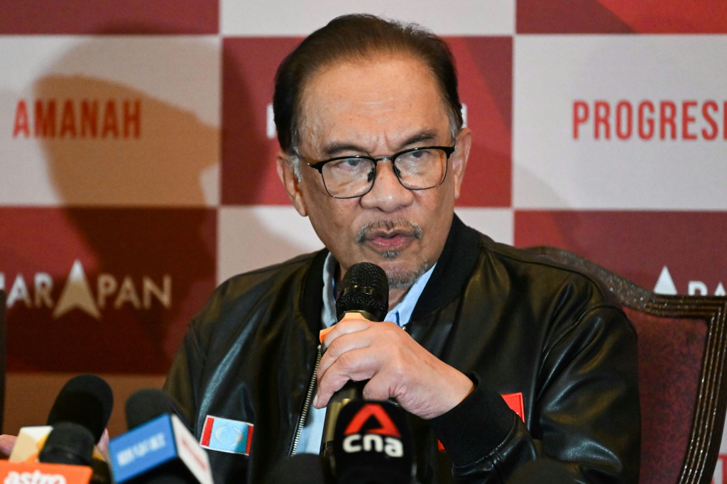 Opposition leader Anwar Ibrahim (pictured) said his coalition had enough seats to form the country's next government, but former premier Muhyiddin Yassin made the same claim about his bloc