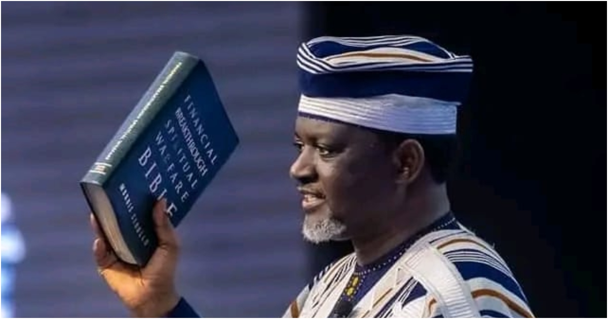 Agyinasare holding a bible in his church