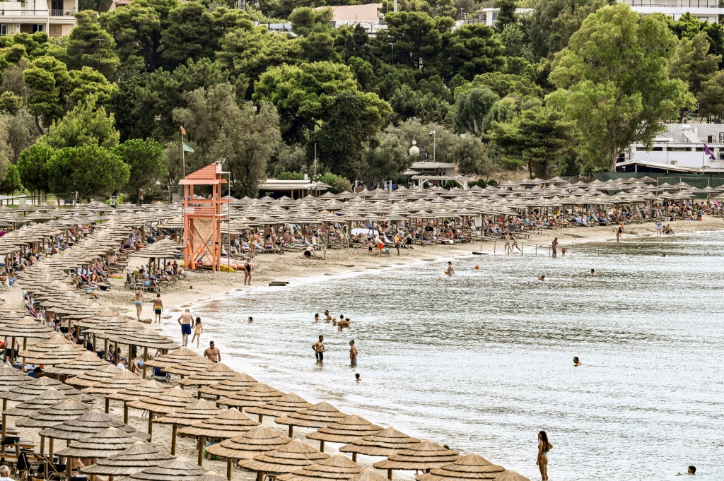 Oceanis beach, south of Athens, is packed with parasols and sun loungers