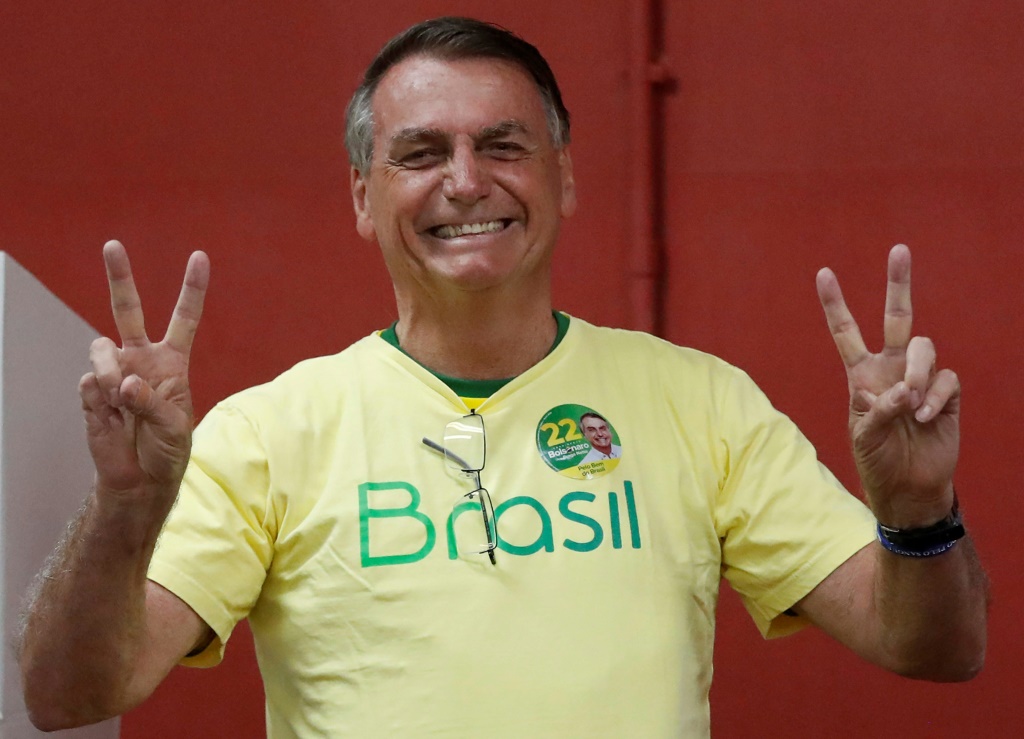 Bolsonaro flashes the 'victory' sign -- also his candidate number, 22 -- as he votes in Rio de Janeiro
