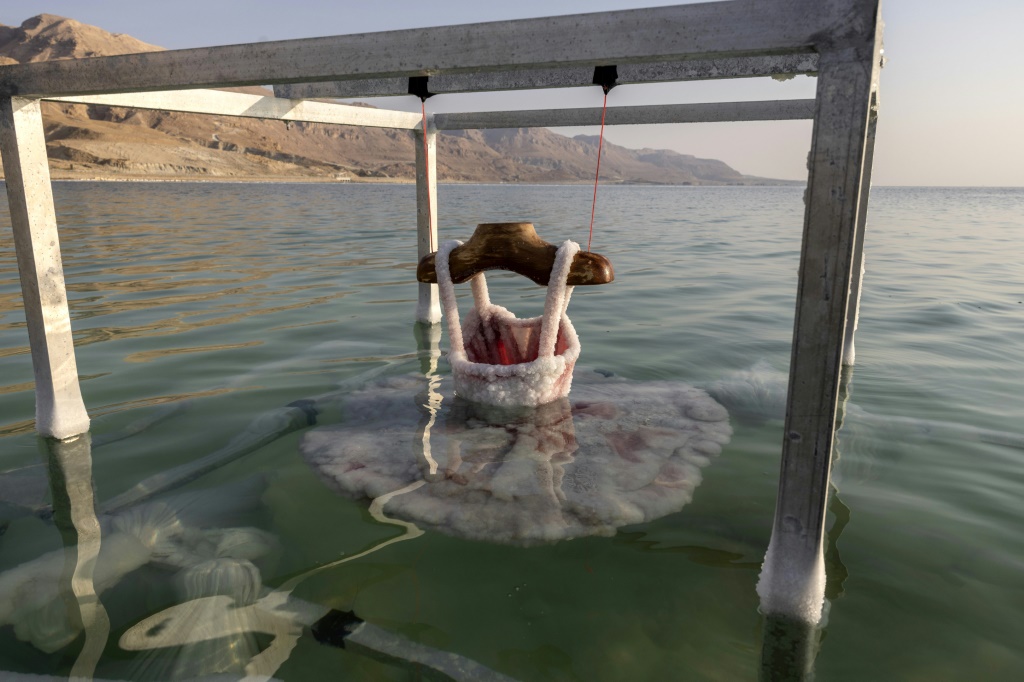 A ballerina dress is submerged in the Dead Sea and encrusted with salt, a project by Israeli artist Sigalit Landau