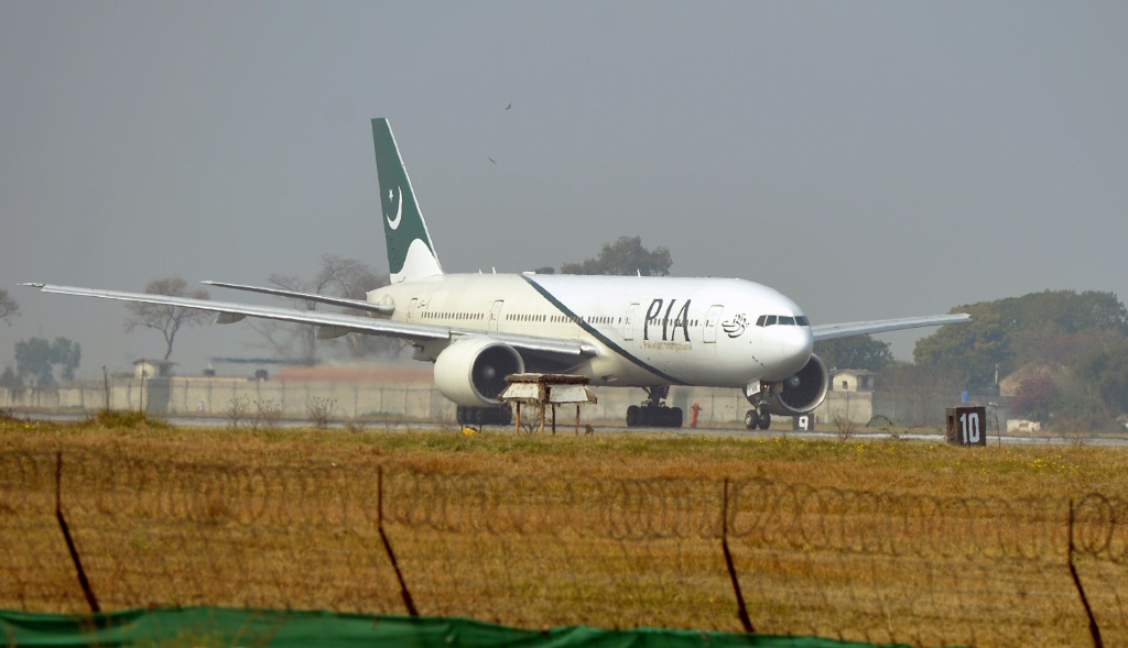A Pakistan International Airline plane taxis on the runway