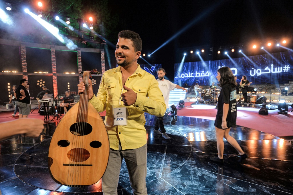 Palestinian musician Ahmed al-Qrinawi holding his oud