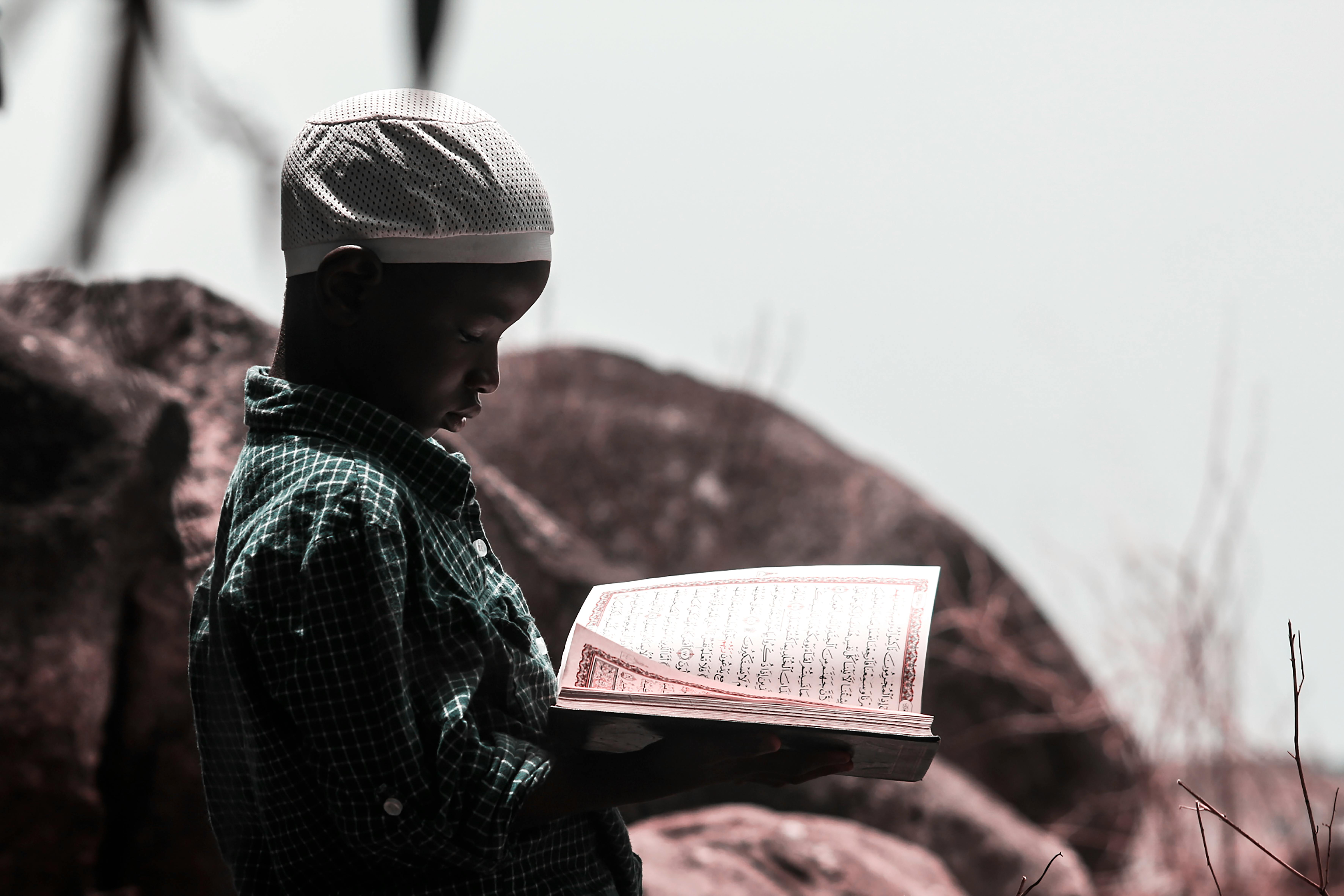 A little Muslim boy reading the Quran