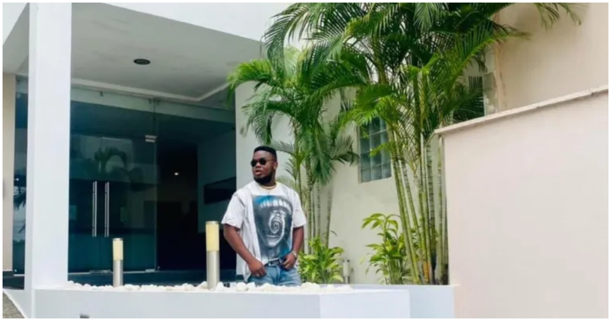 C.I.C. poses in front of his new house in Ghana