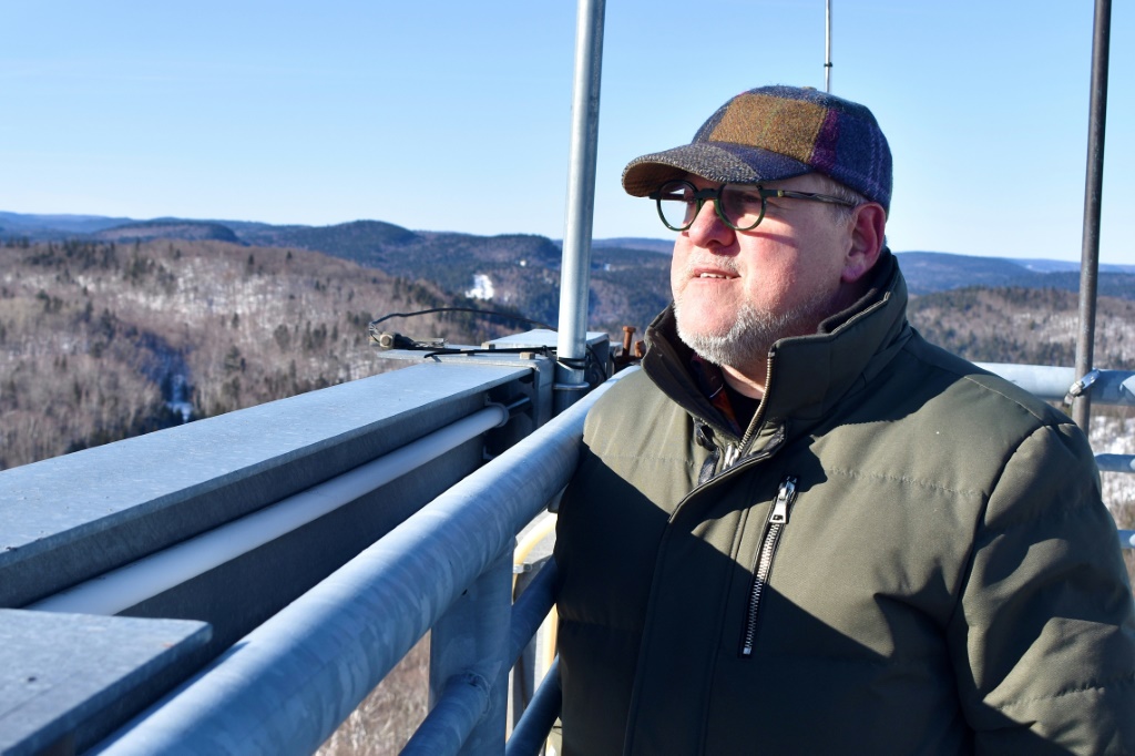 Yvan Lafontaine, whose estate is located on territory claimed by miners, looks at nature and the forest from the top of an observation tower that was built on his land in St-Mathieu-du-Parc, Quebec, Canada
