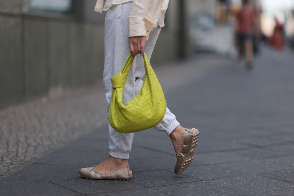 Sonia Lyson is seen wearing a Bottega Veneta lime yellow Jodie leather bag.