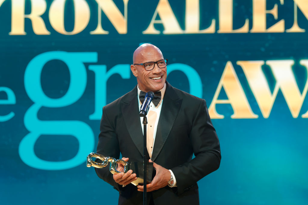 The rock giving a speech at the 2nd Annual Grio Awards while holding an award