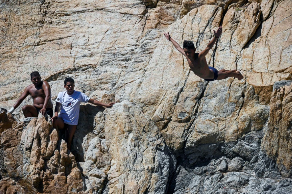 The daredevil divers on Acapulco's legendary cliffs are back, but tourists are slower to return after Hurricane Otis devastated parts of Mexico's coast in late October, 2023