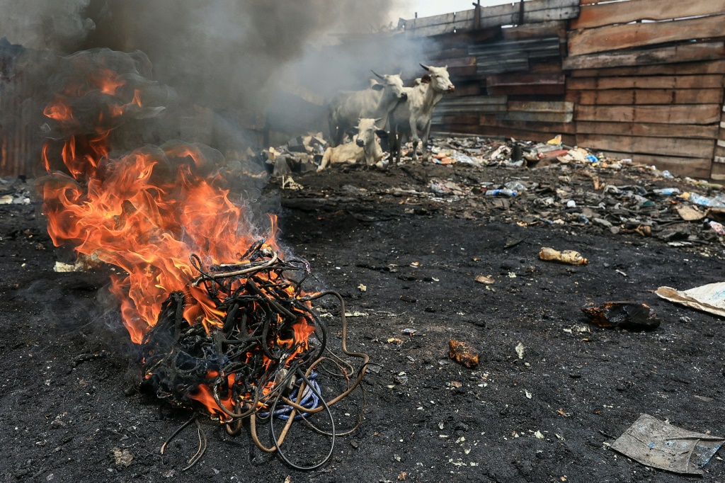 Unlicensed recycling in Yaounde -- electrical cables are burnt in a rubbish bin to recover copper, which is then sold