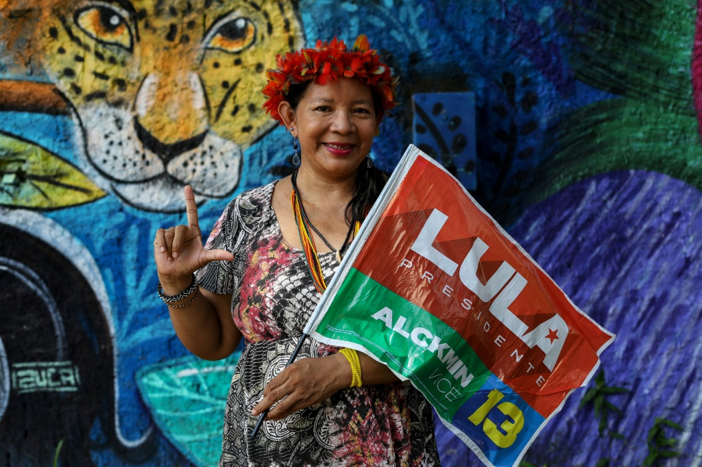 Claudia Bare, an indigenous woman from the Bare tribe, holds a flag in support of Brazil's former president Luiz Inacio Lula da Silva, who is running to hold the office again