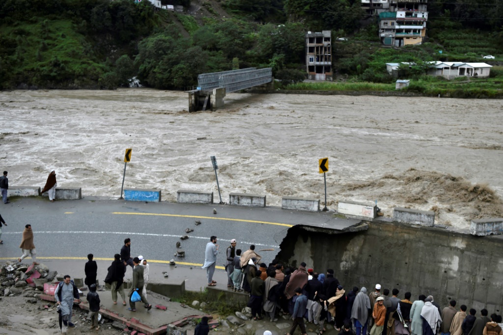 Flood-swollen rivers in Pakistan's mountainous north have washed away scores of bridges and damaged long stretches of road