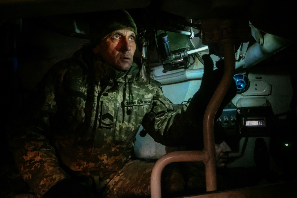 A Ukrainian artilleryman looking through a howtizer periscope towards Russian positions near an undisclosed frontline position in eastern Ukraine