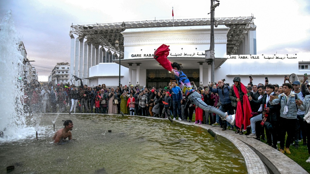 A fan celebrated by jumping into a fountain outside Rabat's Central Railway Station