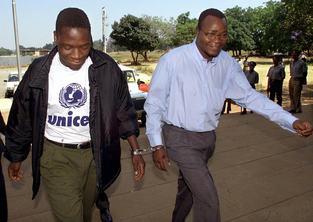Job Sikhala, right, is handcuffed to fellow opposition MP Tafadzwa Musekiwa as they head into court in 2000 for allegedly threatening to use violence to overthrow the government. The case was dismissed