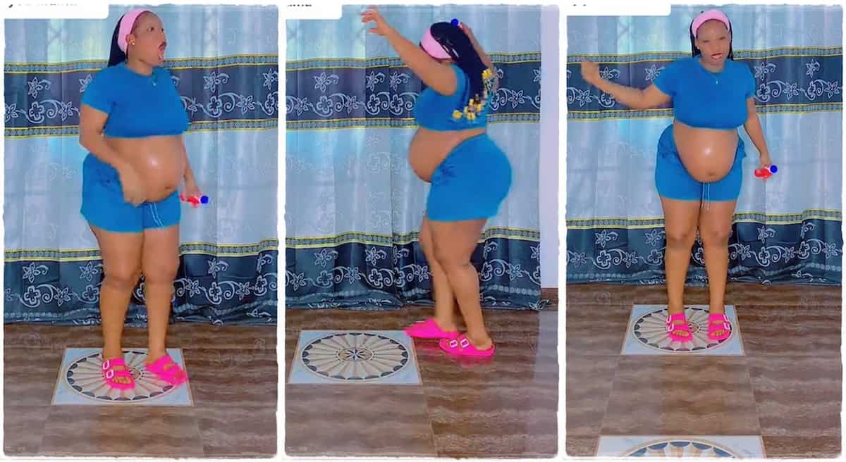 Pregnant woman dancing inside her room.