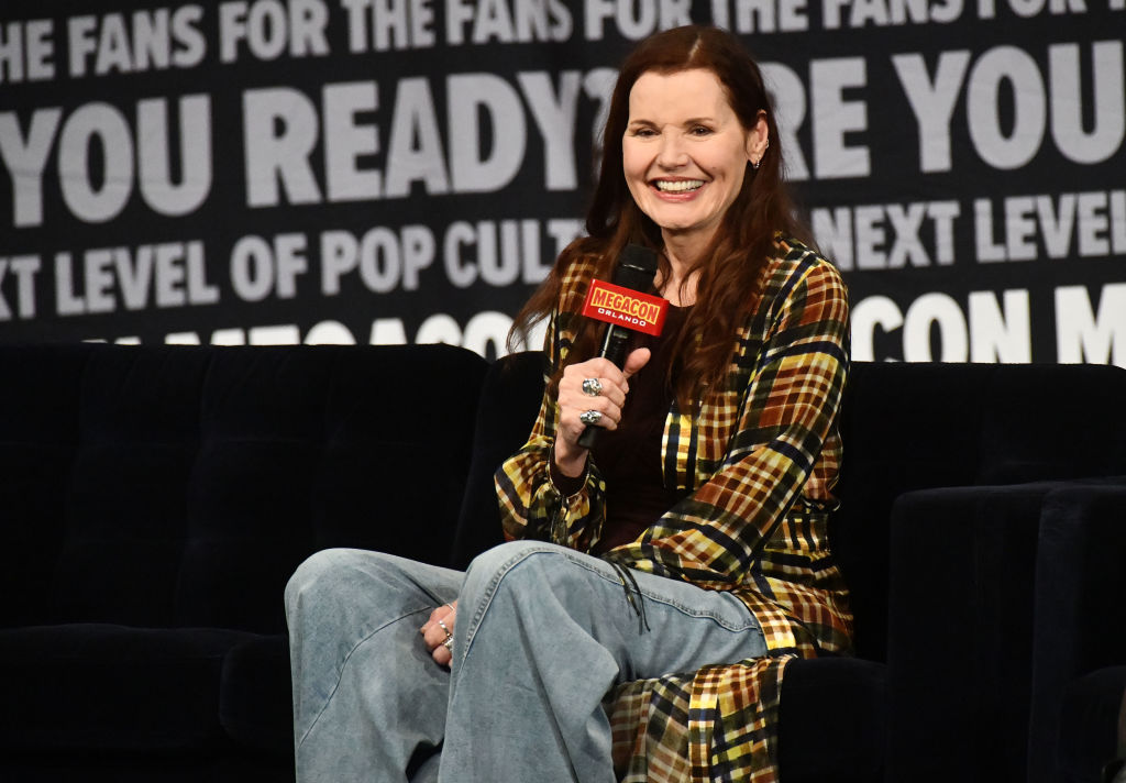 Geena Davis in a flannel cover up and denim jeans as she speaks during a Q&A session
