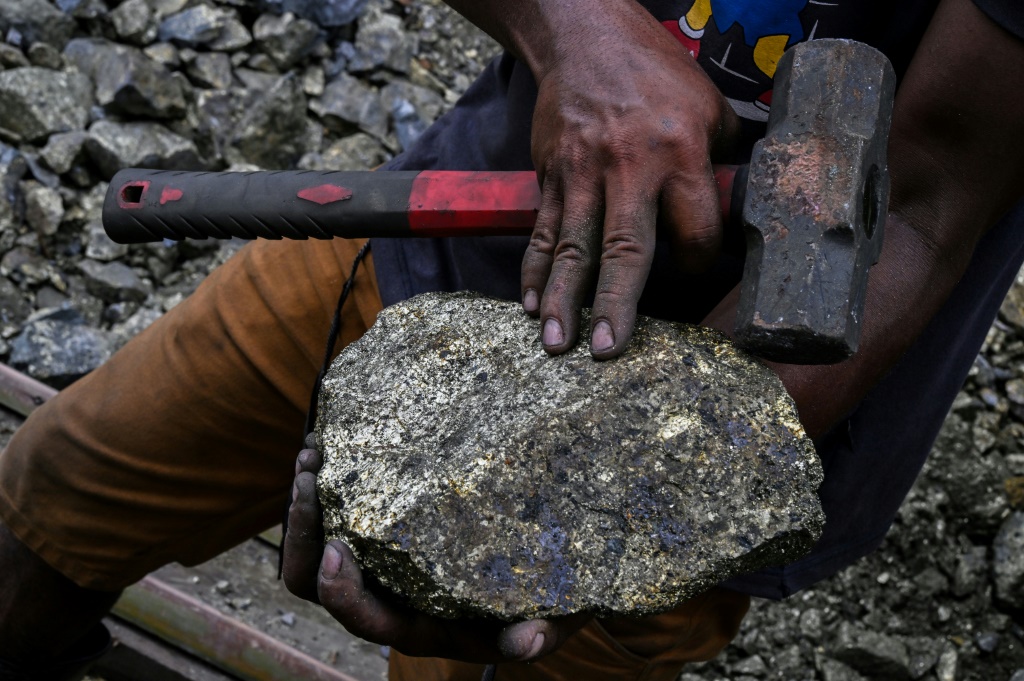 Copper miner Valmir Souza Silva shows off a recent find from one of the 100 or so illegal mines, in Canaa dos Carajas, Para State, Brazil