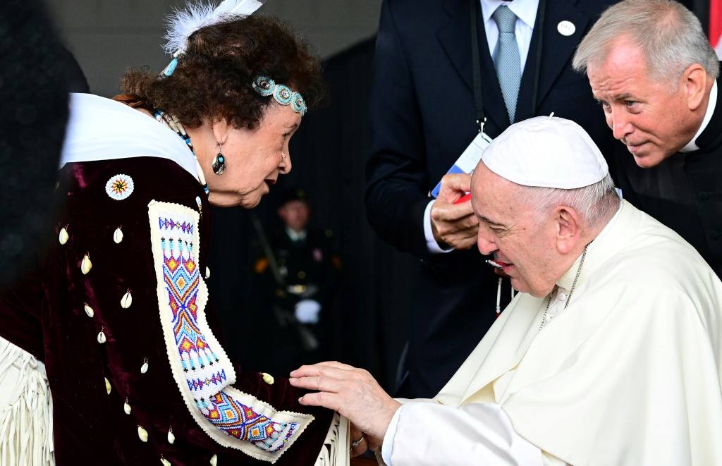 Pope Francis meets a member of an Indigenous tribe during his welcoming ceremony at Canada's Edmonton International Airport on July 24, 2022