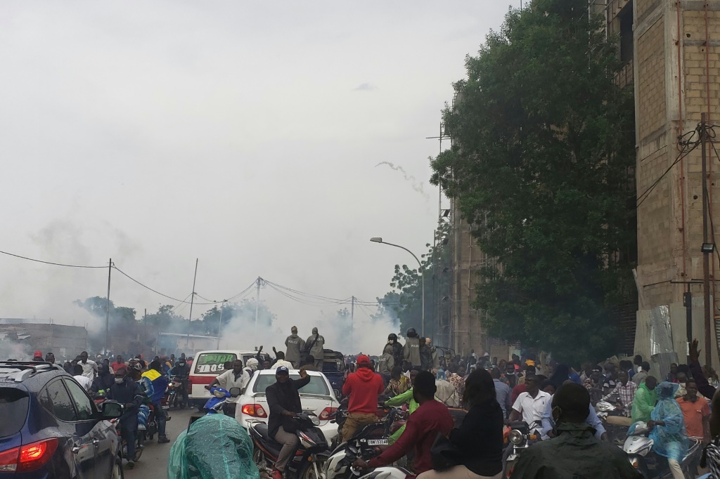 Police fired tear gas to disperse a large crowd surrounding opposition leader Succes Masra's car