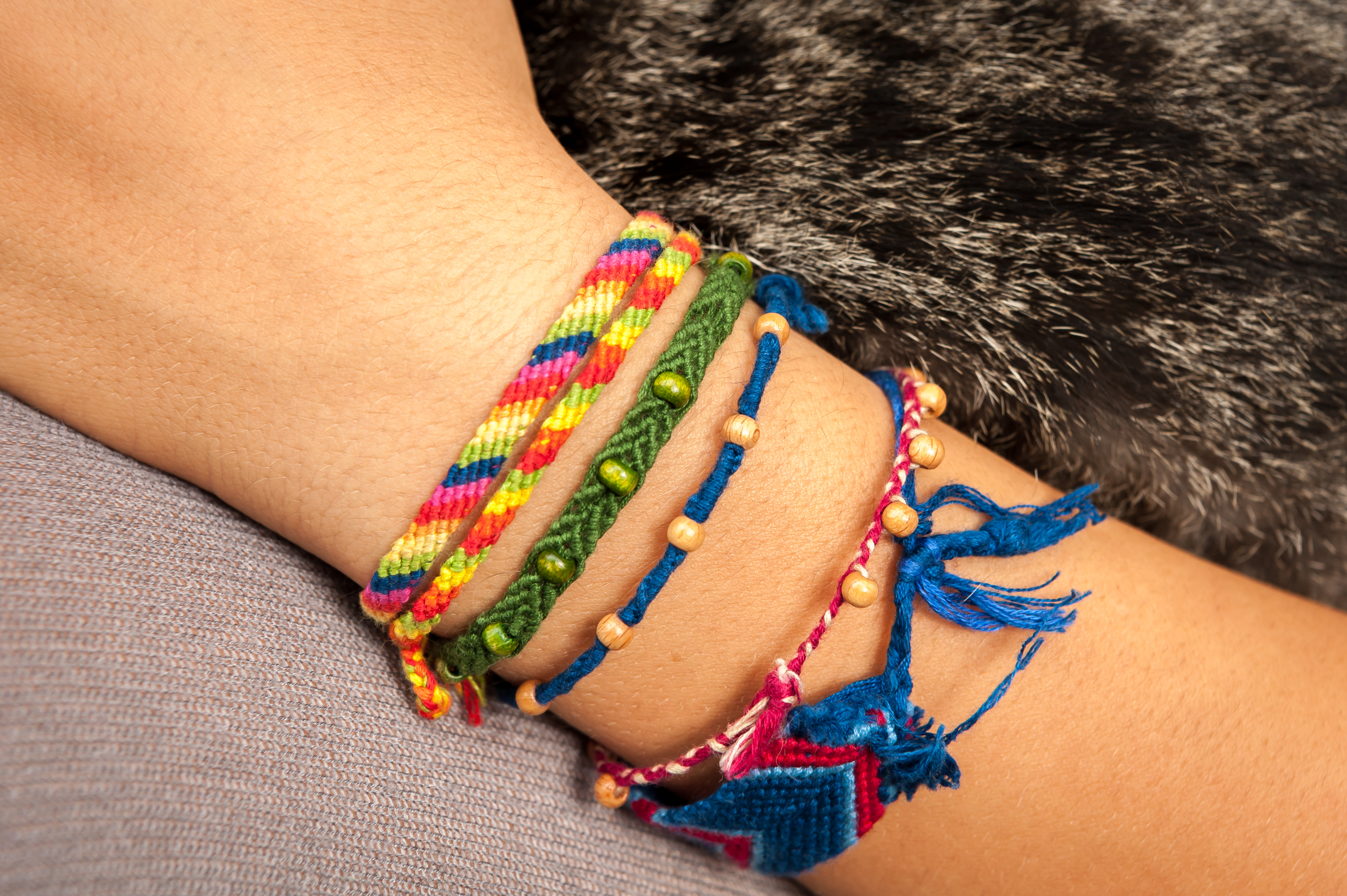 A lady wears several friendship bracelets on her wrist