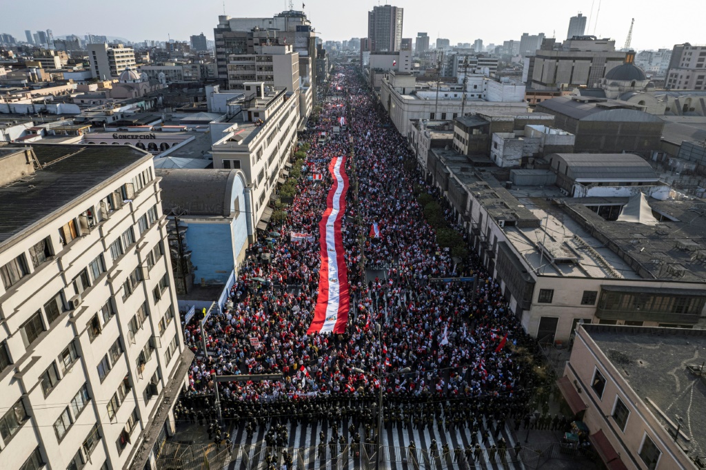 Shouting 'Castillo out!' thousands of protesters march through the streets of Lima on November 5, 2022 to demand the resignation of leftist Peruvian President Pedro Castillo