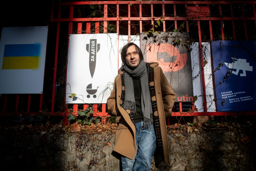 Ukrainian graphic designer Mykola Kovalenko with some of his posters in Bratislava, Slovakia