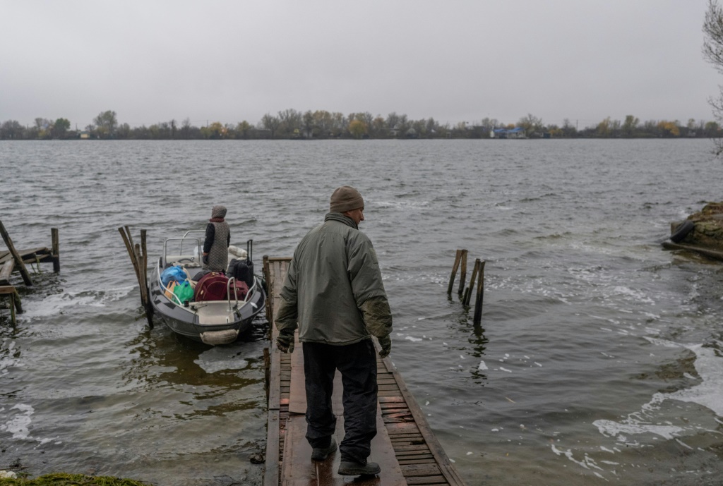 A man and his wife leave their home for their summer residence near the Dnipro River after an attack on an oil depot in Kherson