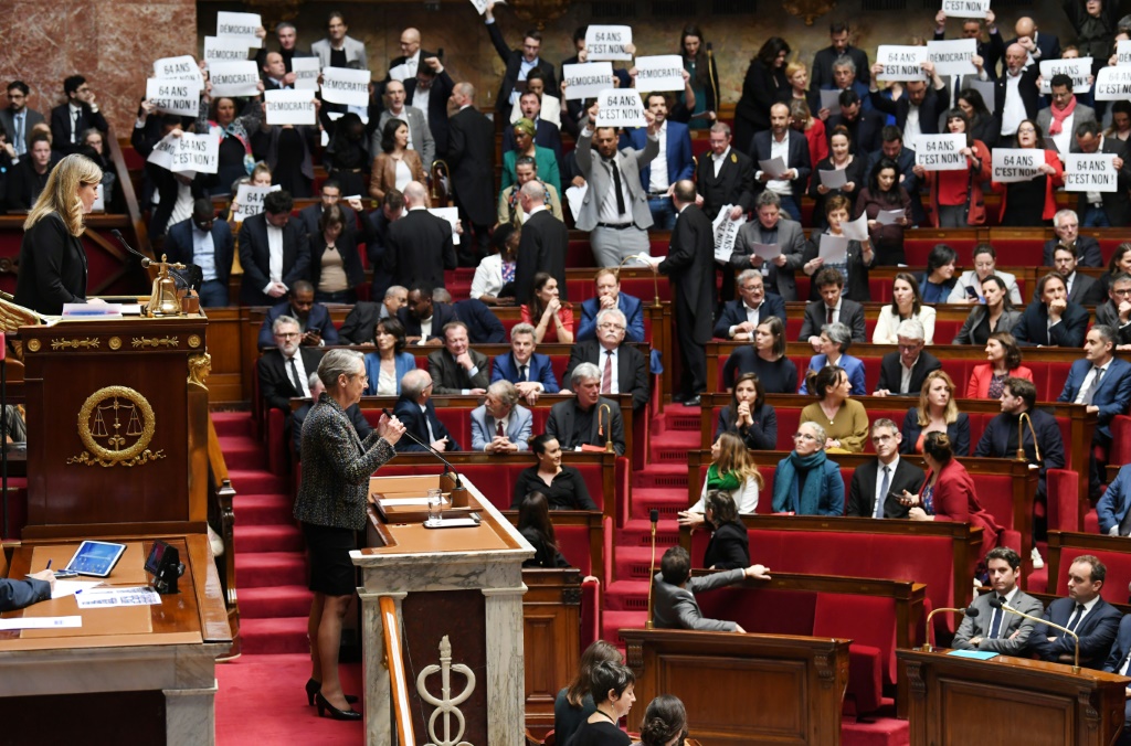 Left-wing oppositions MPs held up signs and jeered Prime Minister Elizabeth Borne as she announced the news