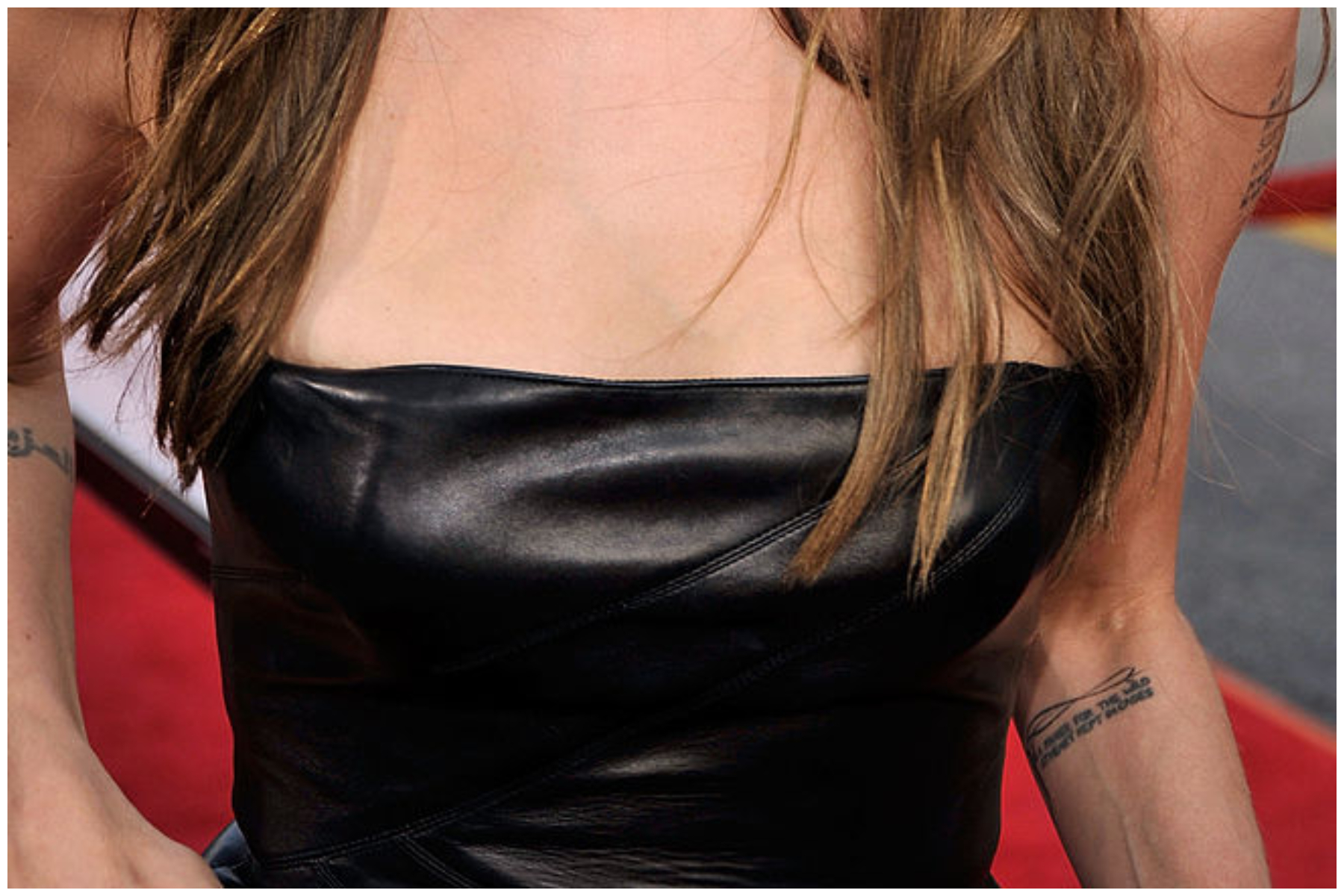 Actress Angelina Jolie's Tennessee Williams tattoo is seen as she arrives at the premiere of Weinstein Co.'s "Inglourious Basterds" held at Grauman's Chinese Theatre in Hollywood, California.