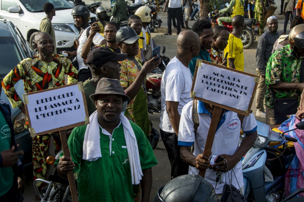 Demonstrators hold up placards during a march against the high cost of living in Cotonou, last April 27, 2024