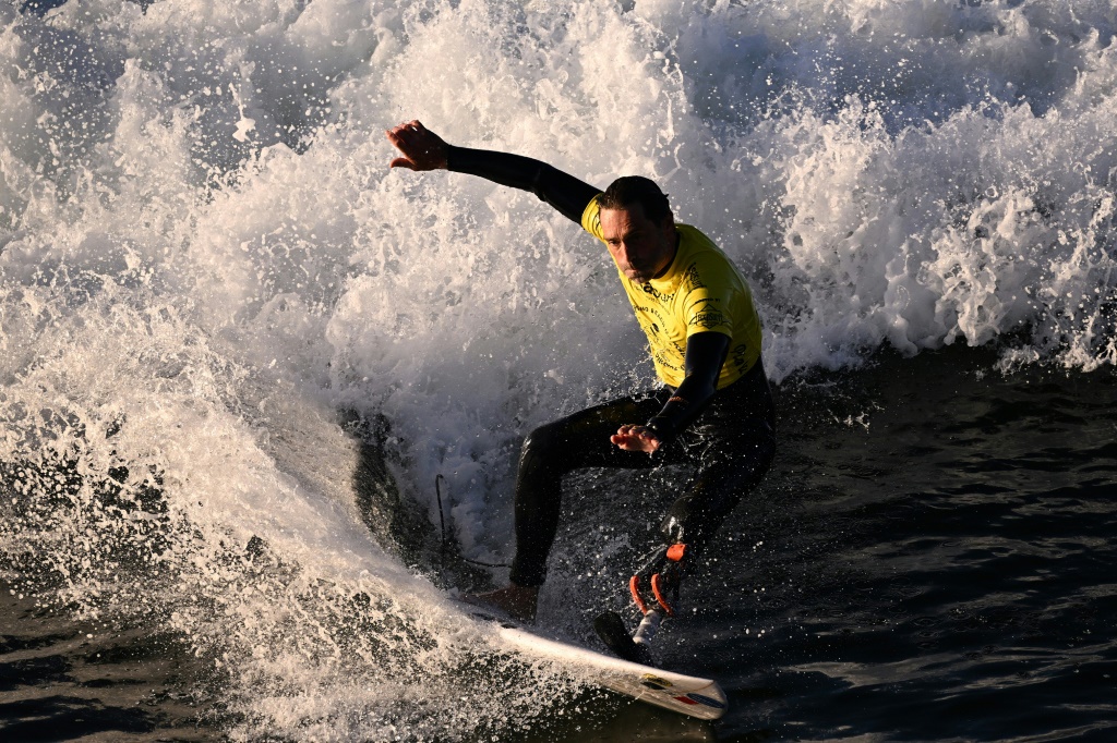 French athlete Eric Dargent, who has a prosthetic foot, surfs in his heat on the second day of competition at the World Para Surfing Championship in Pismo Beach, California, on December 6, 2022