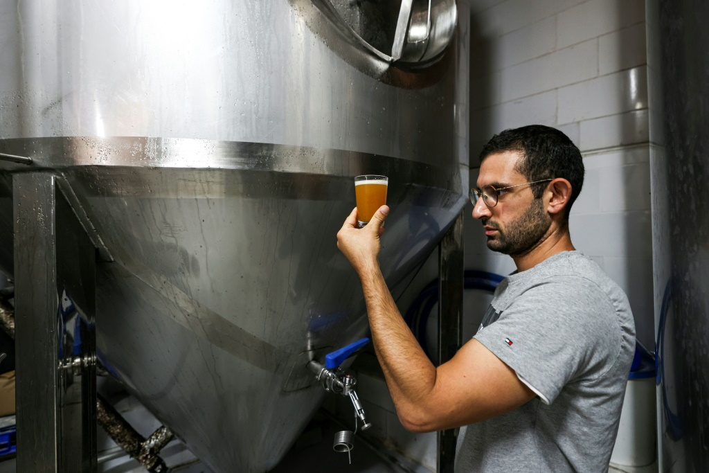 Kanaan Khoury, the son of the brewery founder, checks the beer at the brewery in the village of Taybeh, which means 'it's delicious' in Arabic